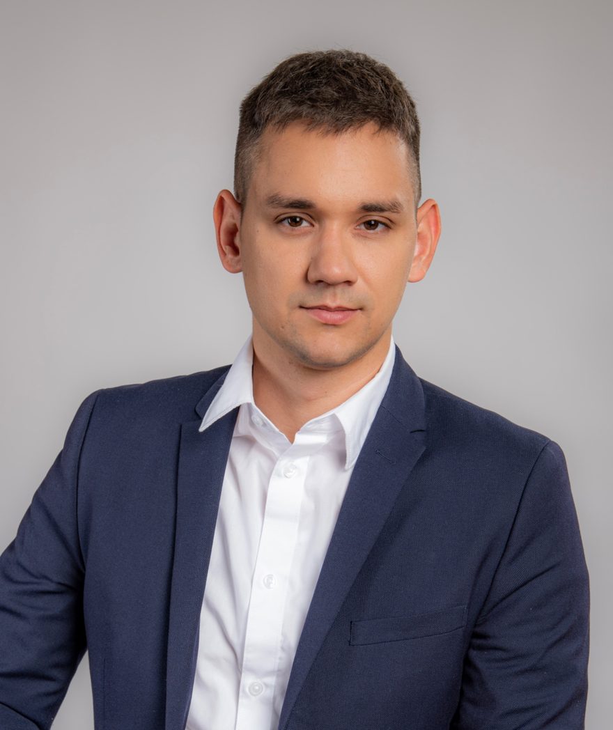 Portrait of Patrik Pusztai in a navy blazer and white shirt